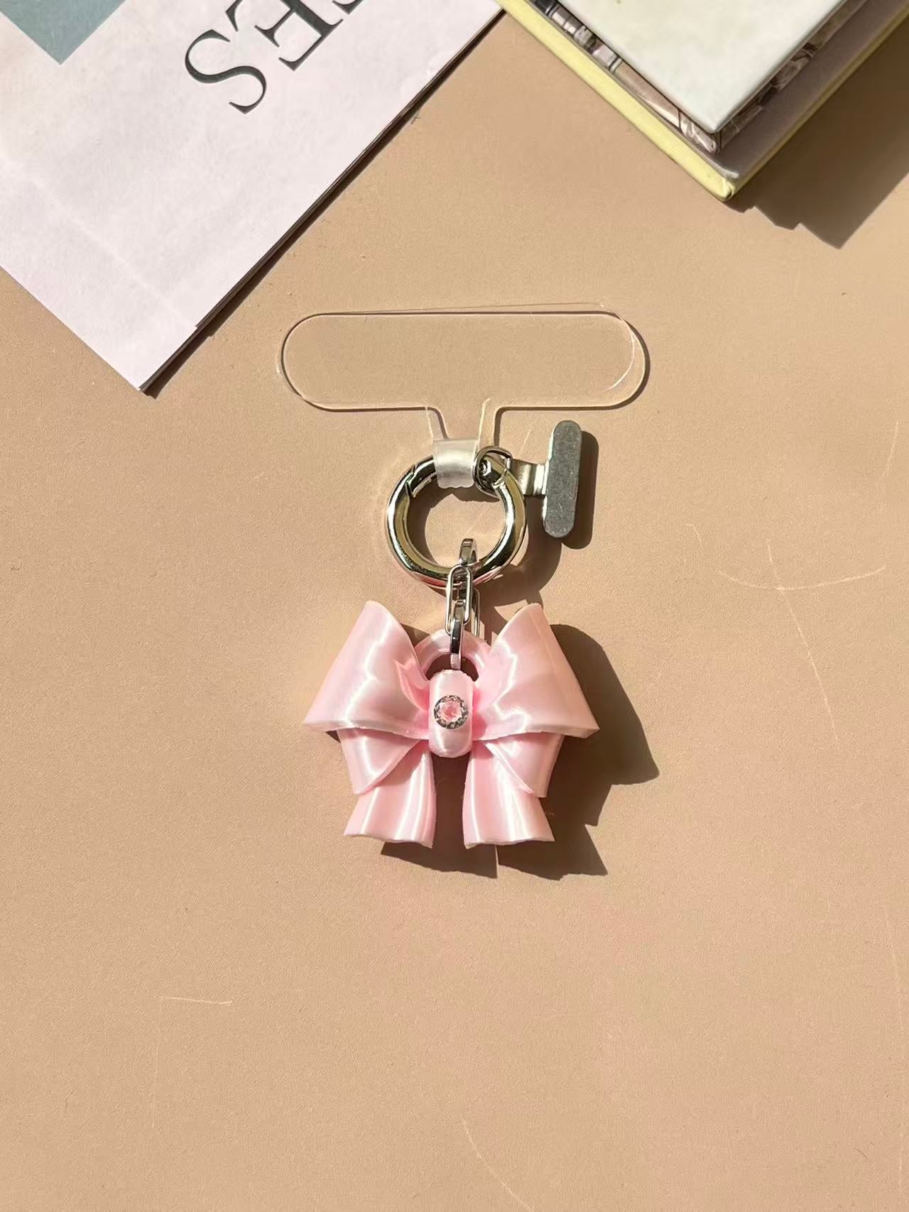 Bow Phone Charm in silk white and silk pink with cubic zirconia by UNICOLOOM
