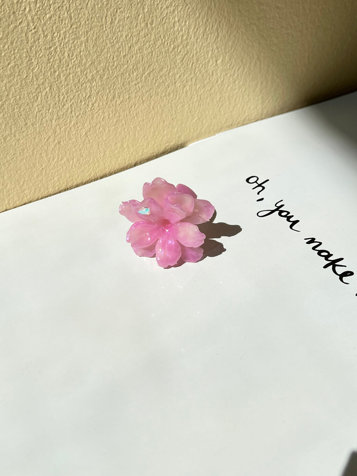 UV Sakura Ring lifestyle styling shot with soft floral mood