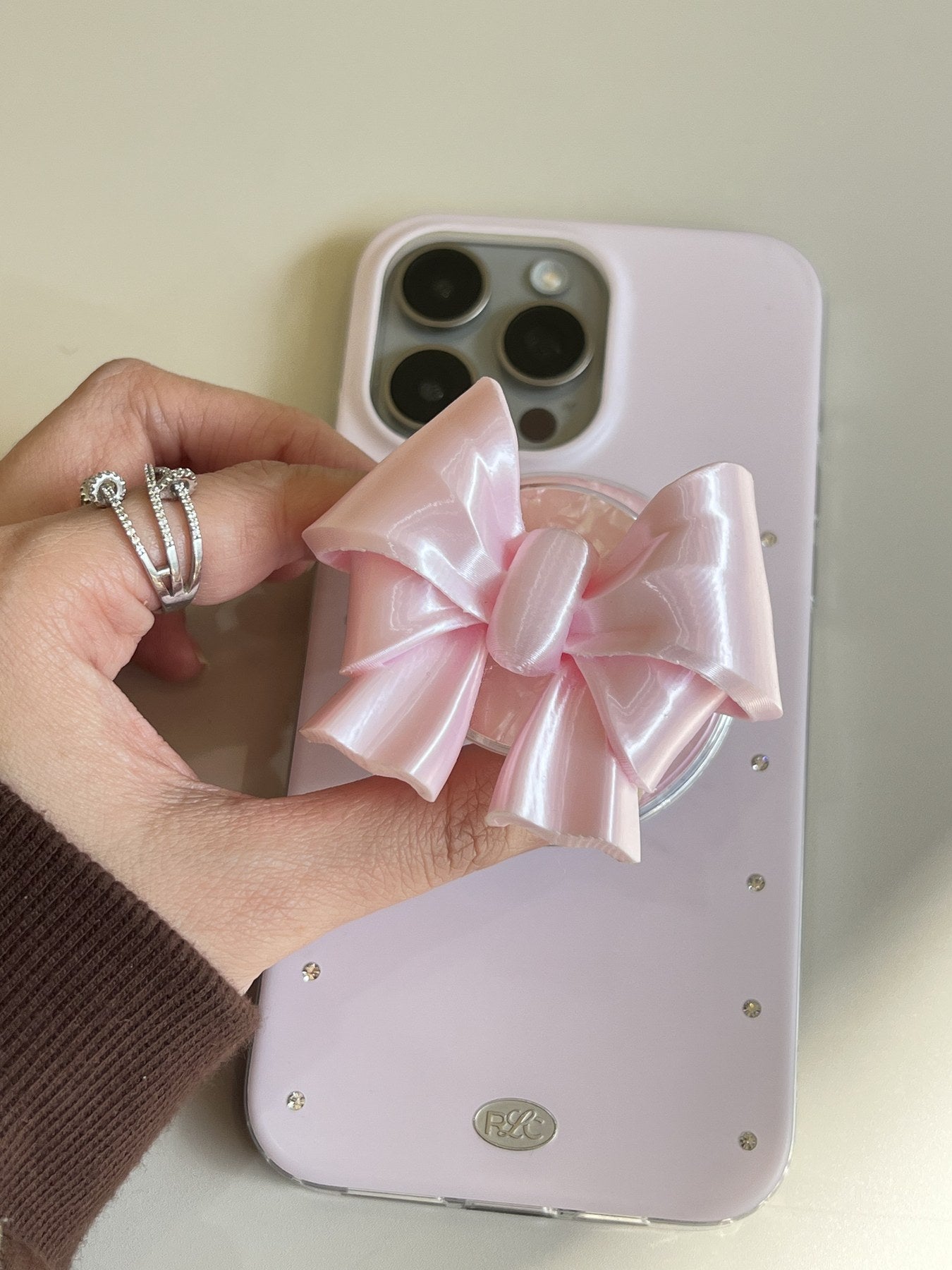 Silk Pink Bow Magnetic Phone Grip handheld lifestyle view by UNICOLOOM