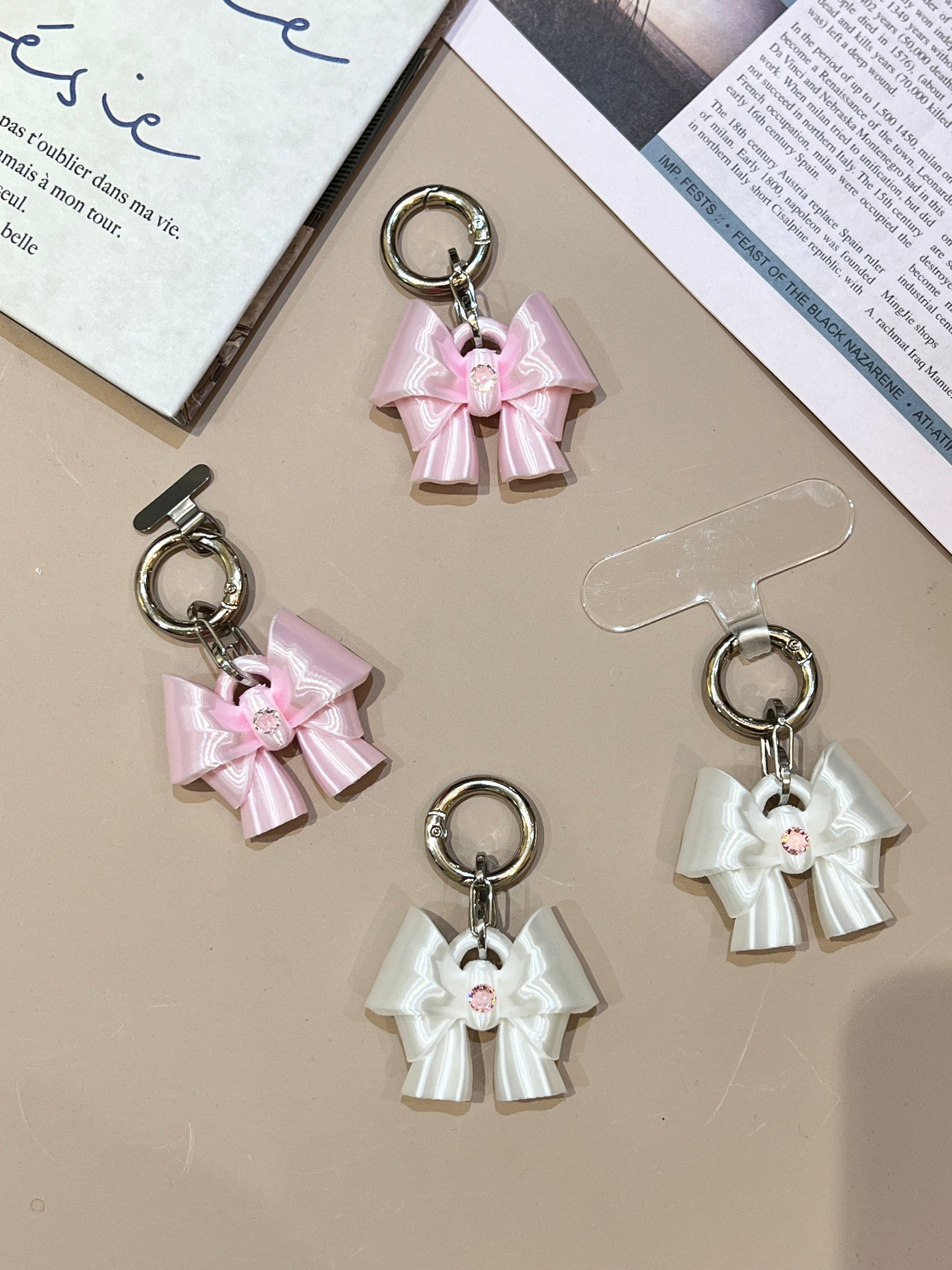 Bow Phone Charm in silk white and silk pink with cubic zirconia by UNICOLOOM