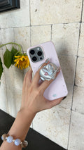 Silk silver Mechanical Heart Magnetic Phone Grip held on an iPhone case