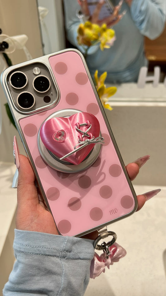 Rose metallic pink Mechanical Heart Magnetic Phone Grip attached to an iPhone case