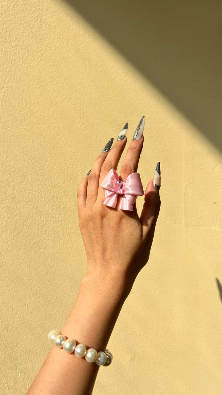Silk Pink Ribbon Bow Ring worn on a hand